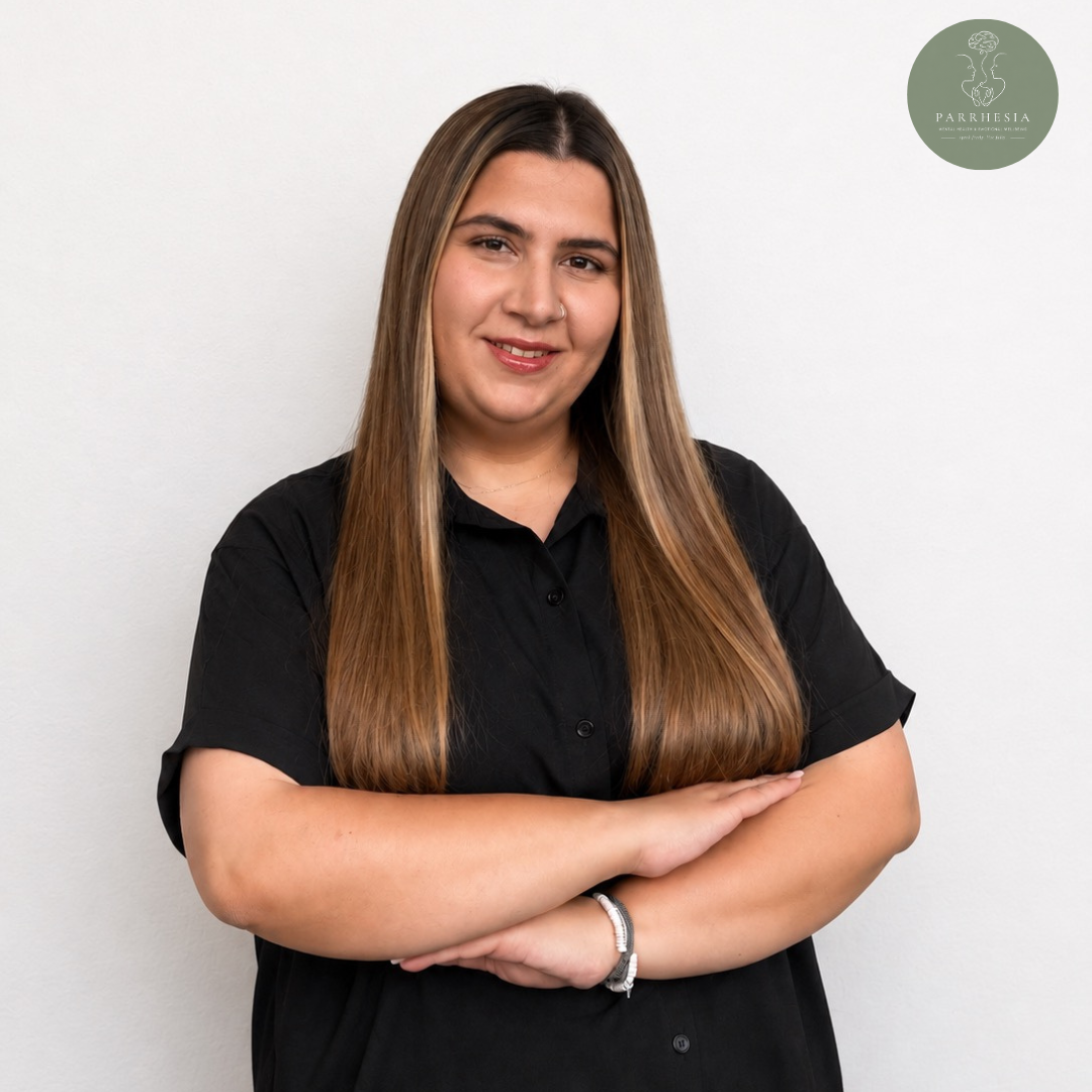Niki Georgiou, psychologist at Parrhesia Cyprus, professional portrait with folded arms, providing psychological support, counselling, and mental health services for individuals in Cyprus.